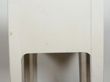 a small white table with a wooden top sitting on top of a carpeted floor