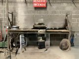 a sign on the wall above a workbench in a garage