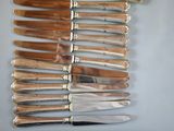 a lot of knives that are laying on a table
