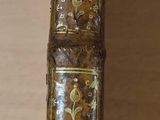 an old book with a knife on top of it