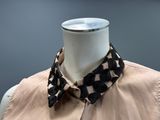 black and white crocheted collar on a mannequin mannequin