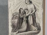 an old picture of a woman holding a child