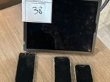 three cell phones sitting on a table next to a laptop