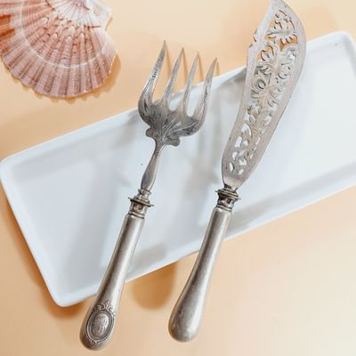 two forks and a knife sitting on a plate