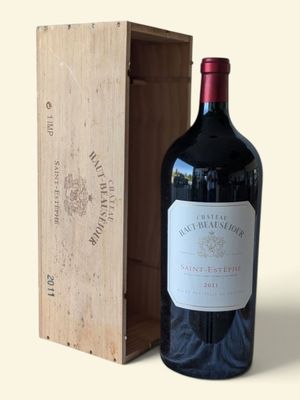 a bottle of wine sitting next to a wooden box