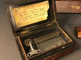 a small wooden box with a writing inside of it