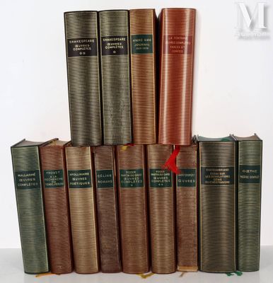 several old books are stacked on top of each other on a table