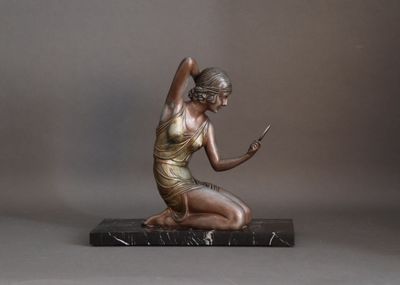bronze statue of a woman sitting on a marble base holding a cell phone