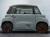 an image of a small grey car with red rims on it