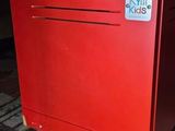 a red locker with a sign on it on the floor