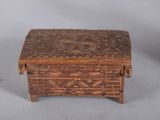 a small wooden box that has a design on it