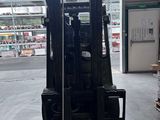 a fork lift truck in a warehouse with boxes on the floor