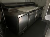 a kitchen with stainless steel cabinets and a white counter top