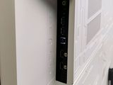 an image of a wall mounted tv with a remote control
