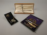 a box with a pen and a pair of scissors in it