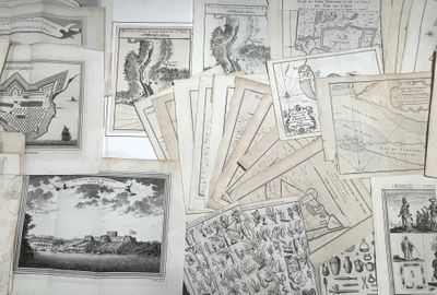 a lot of old maps and postcards on the table