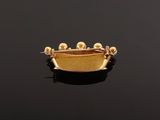 a close up of a gold plated ring with pearls