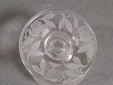 a clear glass cup with a flower design on it