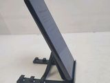 a cell phone that is on a stand on the table