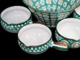 a bowl and cups that are sitting on a table