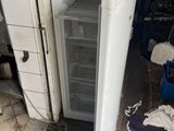 a small refrigerator that is sitting in a room