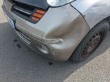a car that has been badly damaged and is parked on the street