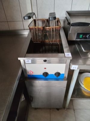 an image of a commercial kitchen with a fryer and a sink
