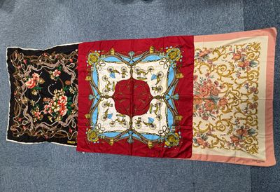 three different types of silk scarves on a blue carpet