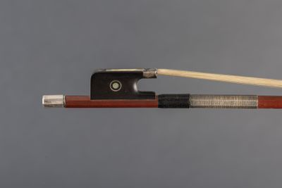 violin bow and bow rest on a gray background