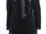 a black velvet coat with embroidered trim and buttons on a mannequin mannequin mannequin mannequin mannequin mannequin mannequin
