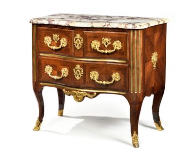 a small chest of drawers with marble top on it
