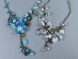deux colliers composés de perles bleues et transparentes sur un fond blanc