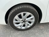 a close up of a tire on a white car