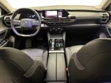 the interior of a car with a steering wheel, dashboard, and dashboard controls