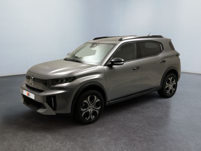 the silver suv is parked in a room with a black floor