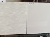 two refrigerators stacked on top of each other in a room