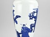 a blue and white vase sitting on a table