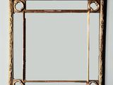 an image of a gold framed mirror on a white wall