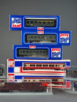 a lot of toy trains that are stacked on top of each other