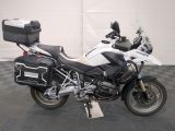 bmw motorcycle parked in a garage with luggage on the back of the bike