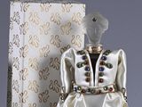 a figurine of a woman in a white dress and a box