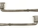 pair of antique cast iron door handles on a white background