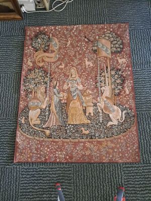 a picture of a tapestry on the floor next to a pair of shoes