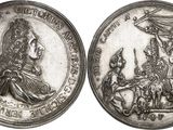 a close up of a silver coin with a picture of a man and woman on it