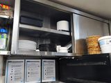 a small kitchen with a lot of dishes on the counter
