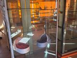 a glass display case with a pair of shoes inside of it