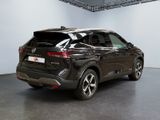 the rear end of a black suv parked in a showroom