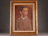 portrait of a man in a brown sweater and blue shirt in a gold frame