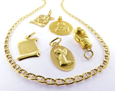 a close up of a gold necklace with various charms on it