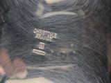 a close up of a dog ' s hair with a tag on it